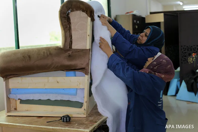 Palestinians disabled work on wood to make furniture during participate in a project titled "Erada" funded by the Turkish President Ragab Ardogan at the Islamic university, in Gaza City, on January 20, 2016. Photo by Moh...