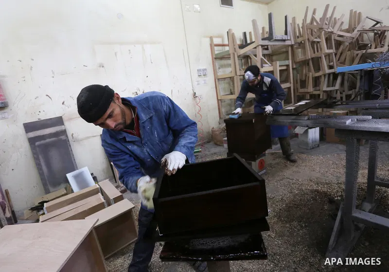 Palestinians disabled work on wood to make furniture during participate in a project titled "Erada" funded by the Turkish President Ragab Ardogan at the Islamic university, in Gaza City, on January 20, 2016. Photo by Moh...