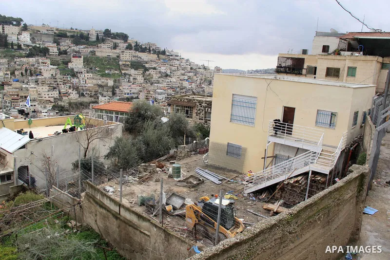 Israeli settlers sit on the balcony of house which the Palestinian Abu Tir family has for years that was taken over by Israeli settlers backed by police in the East Jerusalem neighbourhood of Silwan on Jan. 20, 2016. Sil...