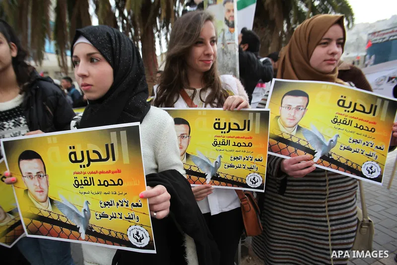 Palestinians take part in a demonstration demanding the release of Palestinian journalist Mohammed al-Qiq from Israeli jails, in the West Bank city of Nablus on Jan. 21, 2016. Qiq, a 33-year-old reporter for Saudi TV cha...
