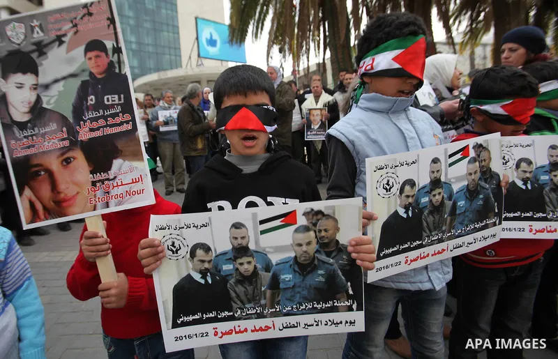 Palestinians take part in a demonstration demanding the release of a 13-year-old Ahmed Manasra, from Israeli jails, in the West Bank city of Nablus on Jan. 21, 2016. Israeli police have accused Manasra, together with his...