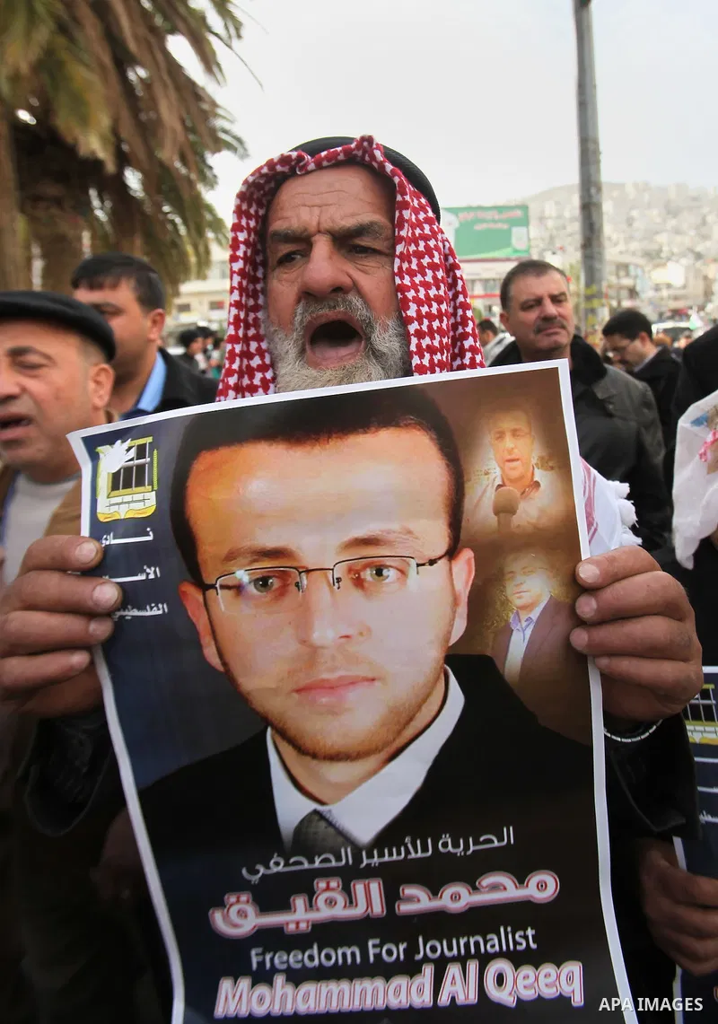 Palestinians take part in a demonstration demanding the release of Palestinian journalist Mohammed al-Qiq from Israeli jails, in the West Bank city of Nablus on Jan. 21, 2016. Qiq, a 33-year-old reporter for Saudi TV cha...