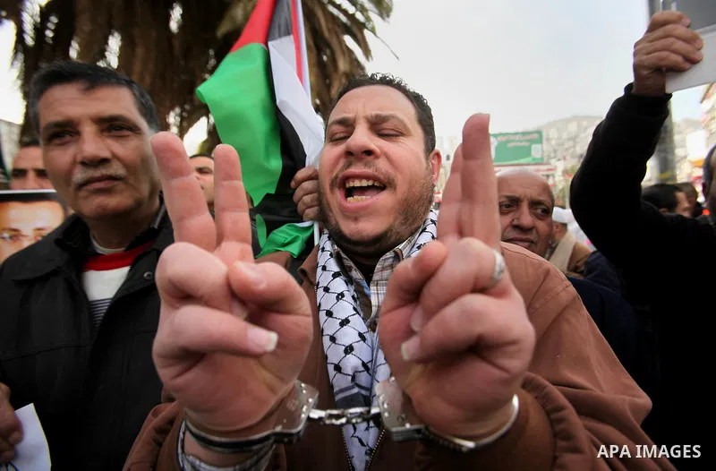 Palestinians take part in a demonstration demanding the release of Palestinian journalist Mohammed al-Qiq from Israeli jails, in the West Bank city of Nablus on Jan. 21, 2016. Qiq, a 33-year-old reporter for Saudi TV cha...