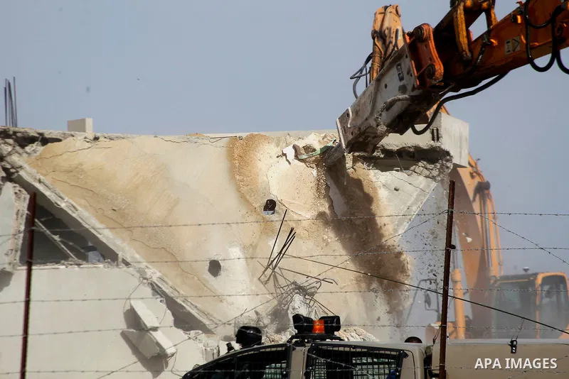 An Israeli bulldozer demolishes a Palestinian house at the order of the Israeli army in the West Bank village of Biet Ula, west of Hebron January 21, 2016. The owners of the house said they were informed by the Israeli a...