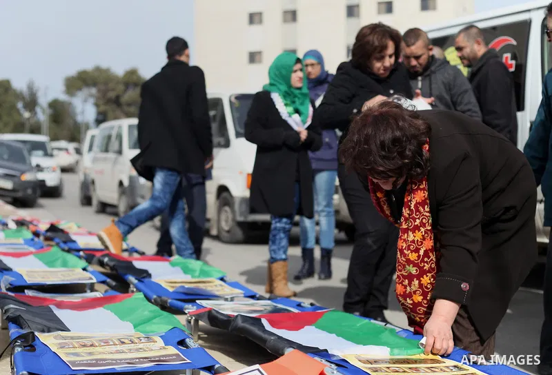 Palestinians take part in a demonstration demanding Israeli authorities to return the bodies of alleged Palestinian attackers in the West Bank city of Ramallah on Jan. 21, 2016. Photo by Shadi Hatem