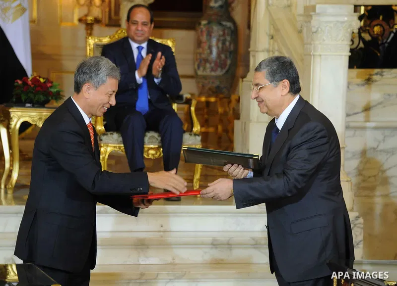 Egypt's President Abdel Fattah al-Sisi and China's President Xi Jinping attend the signature of trade deals in the Egyptian capital Cairo on Jan. 21, 2016. Jinping signed a slew of trade deals with Egypt's leader as part...