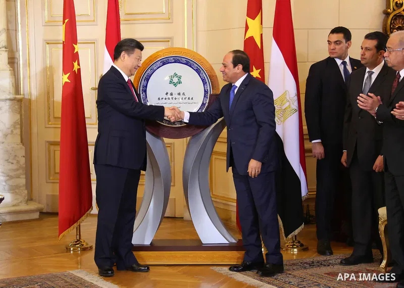 Egypt's President Abdel Fattah al-Sisi shaking hands with his Chinese countpart Xi Jinping in front of a plaque clebrating a Chinese indutrial project in the Suez Canal during a ceremony in the Egyptian capital Cairo. Ji...