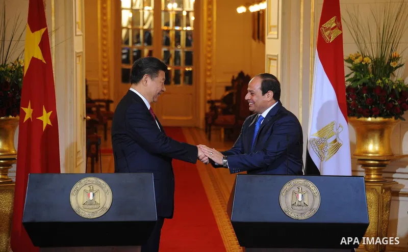 Egypt's President Abdel Fattah al-Sisi shaking hands with Chinese President Xi Jinping following joint a press conference at the Presidential Palace in the Egyptian capital Cairo on Jan. 21, 2016. Jinping signed a slew o...