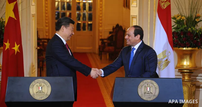 Egypt's President Abdel Fattah al-Sisi shaking hands with Chinese President Xi Jinping following joint a press conference at the Presidential Palace in the Egyptian capital Cairo on Jan. 21, 2016. Jinping signed a slew o...
