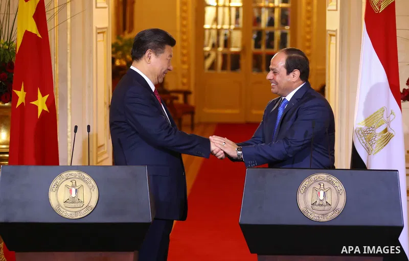 Egypt's President Abdel Fattah al-Sisi shaking hands with Chinese President Xi Jinping following joint a press conference at the Presidential Palace in the Egyptian capital Cairo on Jan. 21, 2016. Jinping signed a slew o...