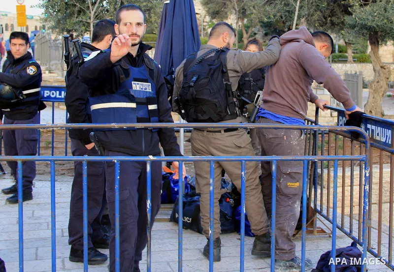 Israeli police inspect a Palestinian youth in front of Damascus gate, in Jerusalem's old city on Jan. 21, 2016. Two Palestinian minors were detained from Jerusalem district. One was identified as Muhammad Yaghmur, 14. To...