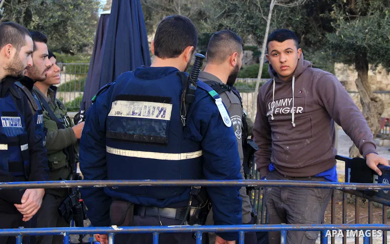 Israeli police inspect a Palestinian youth in front of Damascus gate, in Jerusalem's old city on Jan. 21, 2016. Two Palestinian minors were detained from Jerusalem district. One was identified as Muhammad Yaghmur, 14. To...