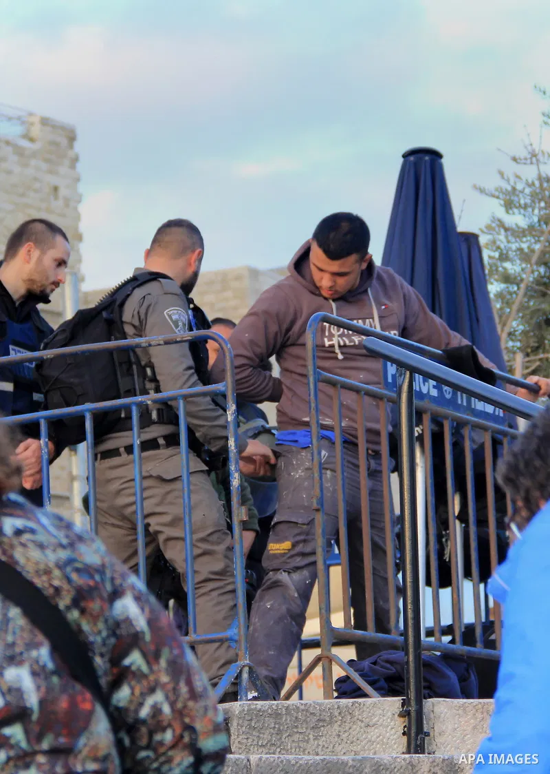 Israeli police inspect a Palestinian youth in front of Damascus gate, in Jerusalem's old city on Jan. 21, 2016. Two Palestinian minors were detained from Jerusalem district. One was identified as Muhammad Yaghmur, 14. To...