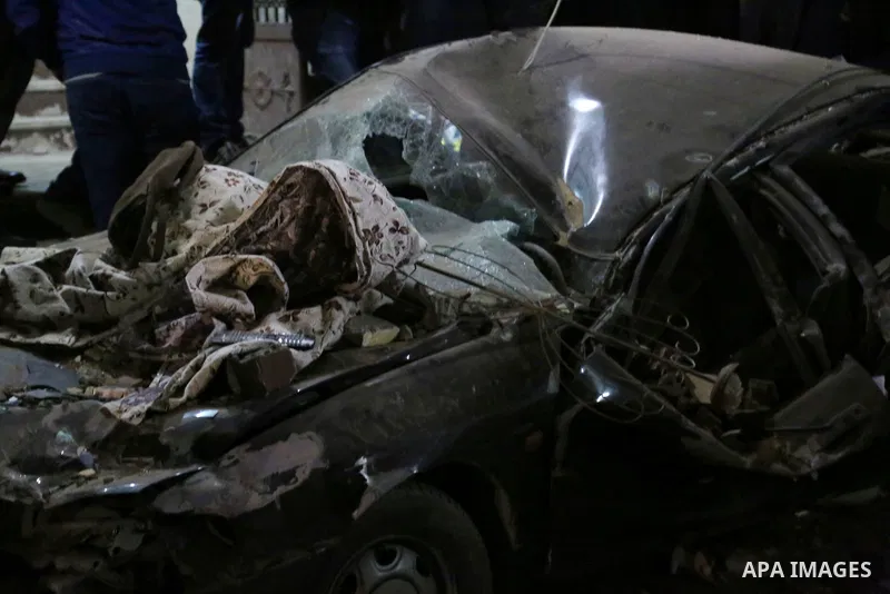 Damaged cars are seen at the scene of a bomb blast in Giza on January 21, 2016. A bomb attack killed six people, including three policemen, on Thursday near a road leading to the pyramids in the Cairo suburb of Giza, sec...