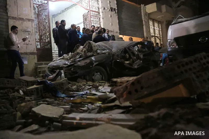 Damaged cars are seen at the scene of a bomb blast in Giza on January 21, 2016. A bomb attack killed six people, including three policemen, on Thursday near a road leading to the pyramids in the Cairo suburb of Giza, sec...