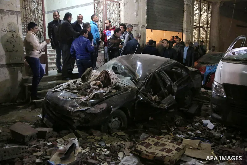 Damaged cars are seen at the scene of a bomb blast in Giza on January 21, 2016. A bomb attack killed six people, including three policemen, on Thursday near a road leading to the pyramids in the Cairo suburb of Giza, sec...