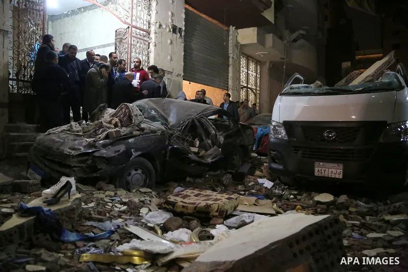 Egyptians gather at the scene of a bomb blast in a main street in Giza on January 21, 2016. A bomb attack killed six people, including three policemen, on Thursday near a road leading to the pyramids in the Cairo suburb...