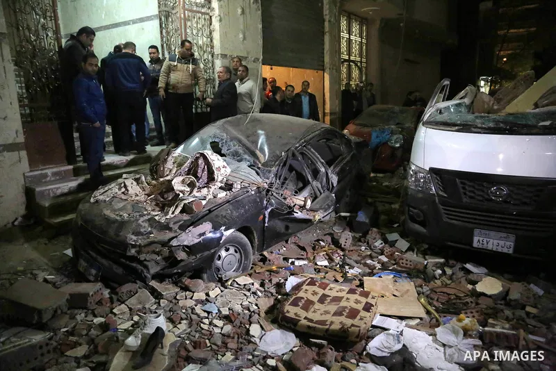 Egyptians gather at the scene of a bomb blast in a main street in Giza on January 21, 2016. A bomb attack killed six people, including three policemen, on Thursday near a road leading to the pyramids in the Cairo suburb...