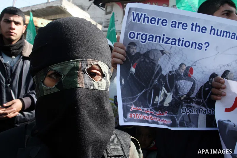 Young masked Palestinians supporting Hamas hold weapons as they take part in a rally calling for an end to the blockade on Gaza, near the border with Egypt, in Rafah in the southern Gaza Strip, January 22, 2016. Gaza, a...