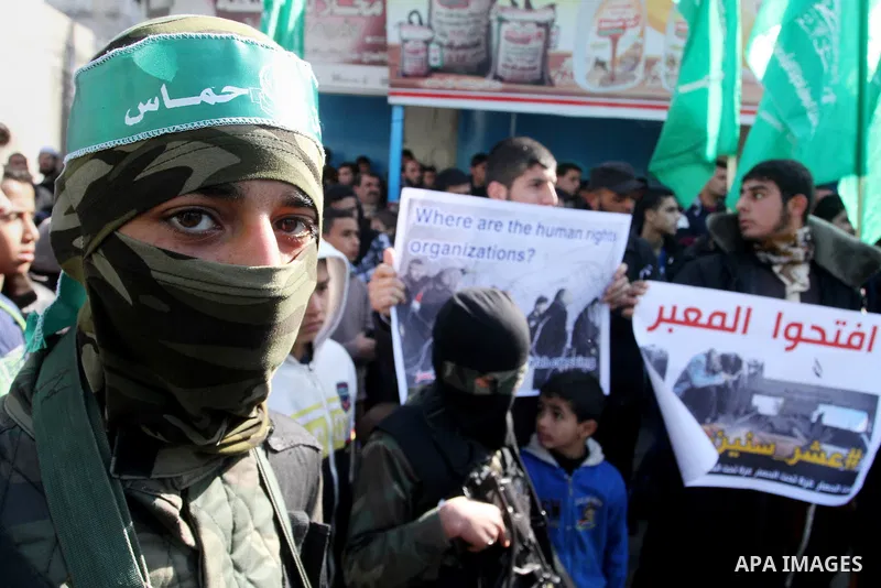 Young masked Palestinians supporting Hamas hold weapons as they take part in a rally calling for an end to the blockade on Gaza, near the border with Egypt, in Rafah in the southern Gaza Strip, January 22, 2016. Gaza, a...