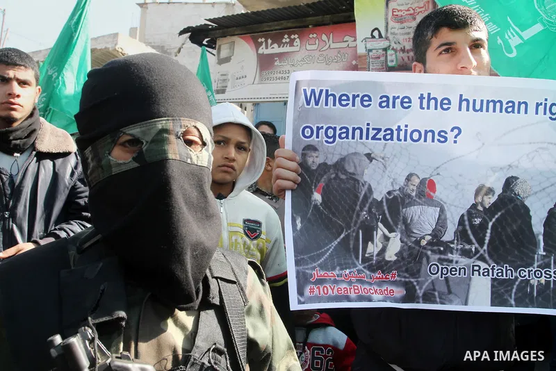 Young masked Palestinians supporting Hamas hold weapons as they take part in a rally calling for an end to the blockade on Gaza, near the border with Egypt, in Rafah in the southern Gaza Strip, January 22, 2016. Gaza, a...