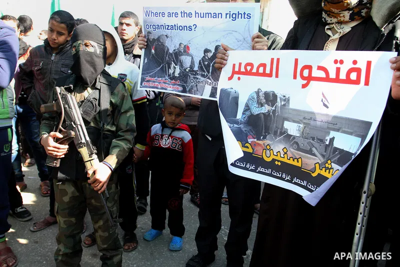 Young masked Palestinians supporting Hamas hold weapons as they take part in a rally calling for an end to the blockade on Gaza, near the border with Egypt, in Rafah in the southern Gaza Strip, January 22, 2016. Gaza, a...