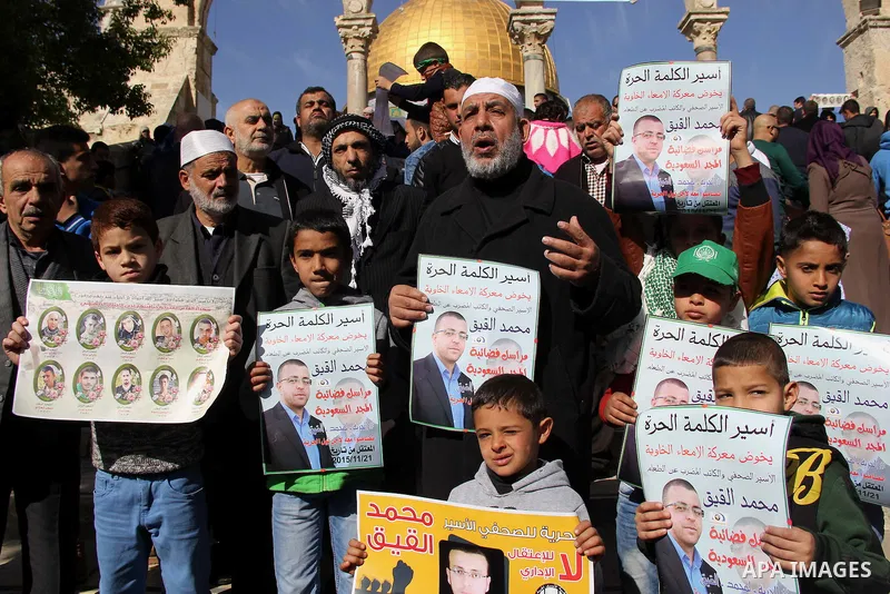 Palestinians carry placards bearing the portraits of 10 reported Palestinian attackers, whose bodies are still under Israeli custody, during a demonstration demanding the release of the bodies and the release of Palestin...