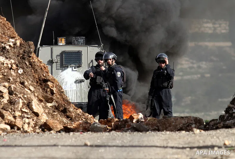 Israeli security forces take position during clashes with Palestinian portesters following a protest against the expropriation of Palestinian land by Israel in the West Bank village of Kafr Qaddum, near the northern city...