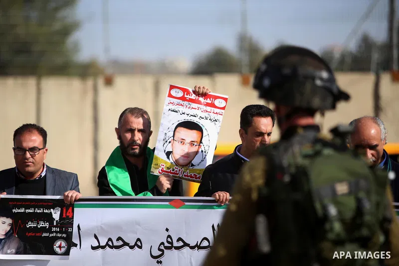 Israeli security forces stand guard during a demonstration demanding the release of Palestinian journalist Mohammed al-Qiq from Israeli jails, in Beit El on the outskirts of the West Bank city of Ramallah on January 22,...