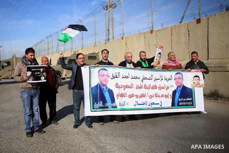 Palestinians take part in a demonstration demanding the release of Palestinian journalist Mohammed al-Qiq from Israeli jails, in Beit El on the outskirts of the West Bank city of Ramallah on January 22, 2016. Qiq, a 33-y...