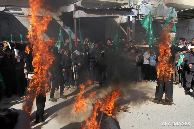 Palestinians supporting Hamas burn effigies depiciting Palestinian President Mahmoud Abbas, Israeli Prime Minister Benjamin Netanyahu and Egyptian President Abdel Fattah al-Sisi during a rally calling for an end to the b...