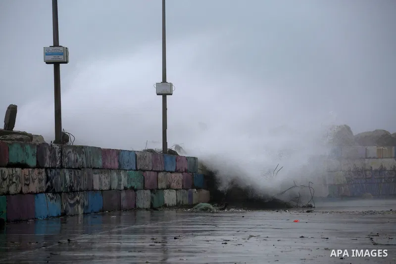 A huge wave is seen crash over a sea wall at the Gaza seaport during a rainy day, in Gaza City, January 24, 2016. Photo by Mohammed Asad