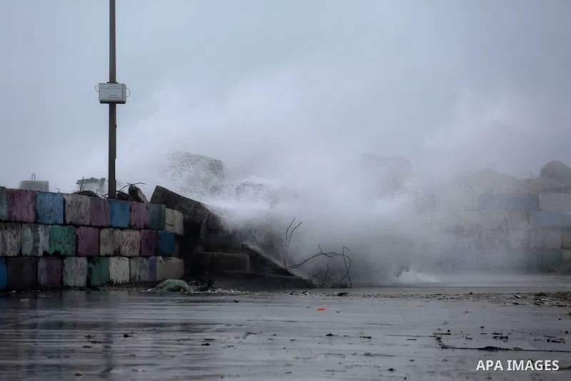 A huge wave is seen crash over a sea wall at the Gaza seaport during a rainy day, in Gaza City, January 24, 2016. Photo by Mohammed Asad