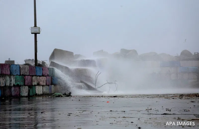 A huge wave is seen crash over a sea wall at the Gaza seaport during a rainy day, in Gaza City, January 24, 2016. Photo by Mohammed Asad