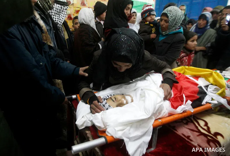 Palestinians mourn around the body of Ruqya Abu Eid, 13, during her funeral, who Israeli military said was shot dead by Israeli soldiers after he tried to stab a soldier, in the West Bank city of Hebron, on January, 24,...