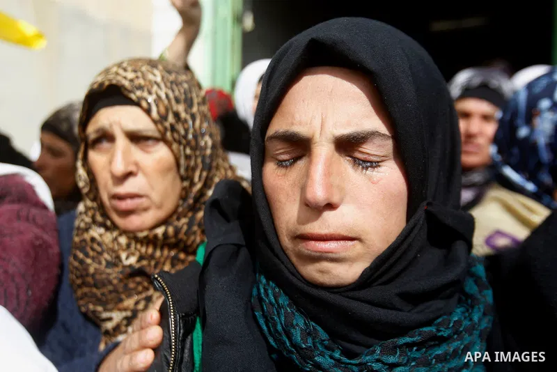 Palestinians mourn of Ruqya Abu Eid, 13, during her funeral, who Israeli military said was shot dead by Israeli soldiers after he tried to stab a soldier, in the West Bank city of Hebron, on January, 24, 2016. Photo by W...