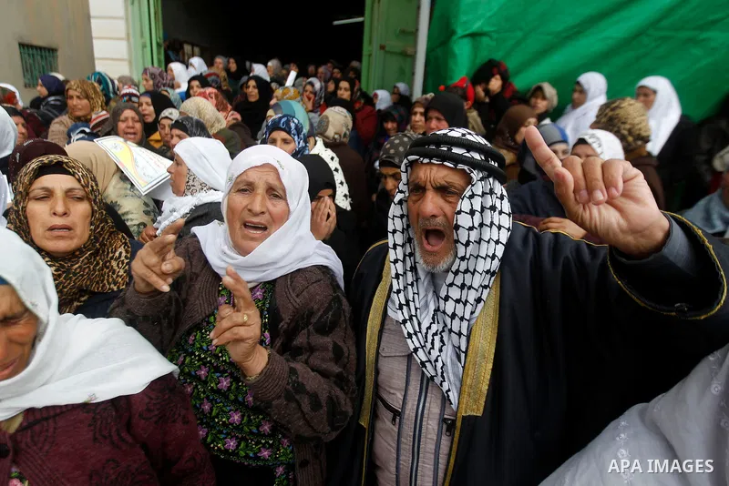 Palestinians carry the body of Ruqya Abu Eid, 13, during her funeral, who Israeli military said was shot dead by Israeli soldiers after he tried to stab a soldier, in the West Bank city of Hebron, on January, 24, 2016. P...