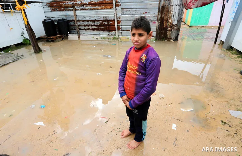 A Palesitinan boy living in containers as temporary replacement for their houses that were destroyed by what witnesses said was Israeli shelling during a 50- day-war in 2014 summer, stand outside his makeshift shelters i...
