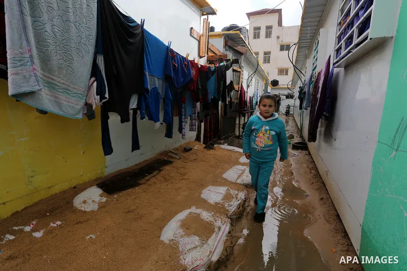 A Palesitinan girl living in containers as temporary replacement for their houses that were destroyed by what witnesses said was Israeli shelling during a 50- day-war in 2014 summer, walks outside her makeshift shelter d...