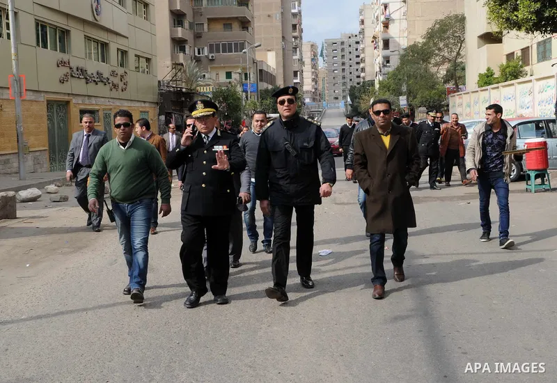 Egyptian officers walk at street on Cairo's landmark Tahrir Square on January 25, 2016, as the country marks the fifth anniversary of the 2011 uprising. Egyptians marked the fifth anniversary of the uprising that toppled...
