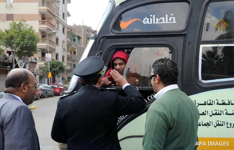 Egyptian policemen give out chocolates to citizens on Cairo's landmark Tahrir Square on January 25, 2016, as the country marks the fifth anniversary of the 2011 uprising. Egyptians marked the fifth anniversary of the upr...