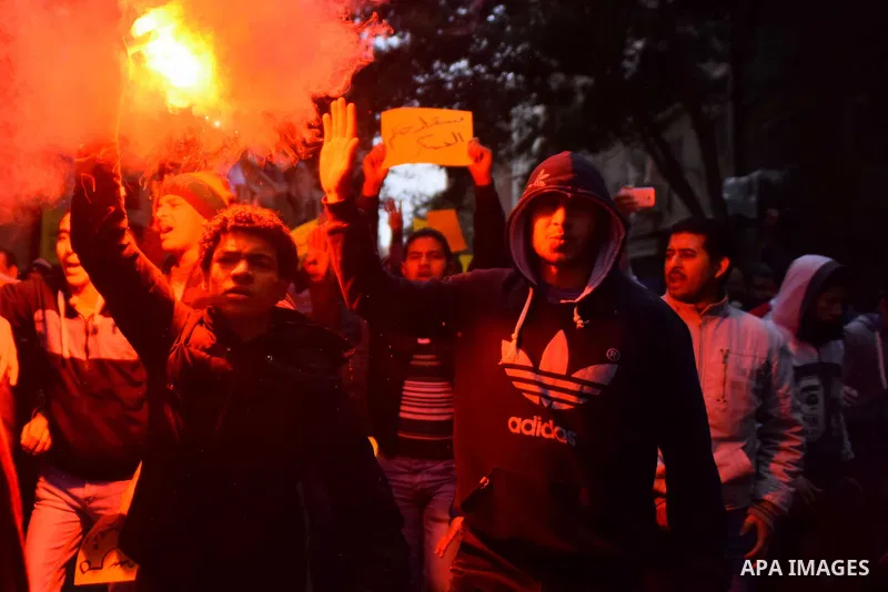 Egyptian supporters of ousted Islamist president Mohamed Morsi light flares and shout slogans during a march in al-Haram neighbourhood in the southern Cairo Giza district on January 25, 2016 but dispersed within minutes...