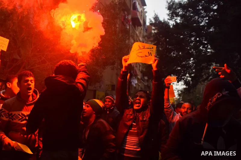 Egyptian supporters of ousted Islamist president Mohamed Morsi light flares and shout slogans during a march in al-Haram neighbourhood in the southern Cairo Giza district on January 25, 2016 but dispersed within minutes...