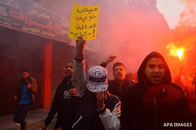 Egyptian supporters of ousted Islamist president Mohamed Morsi march shouting slogans in al-Haram neighbourhood in the southern Cairo Giza district on January 25, 2016 but dispersed within minutes for fear of retaliation...