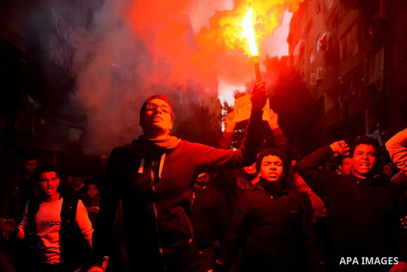 Egyptian supporters of ousted Islamist president Mohamed Morsi light flares and shout slogans during a march in al-Haram neighbourhood in the southern Cairo Giza district on January 25, 2016 but dispersed within minutes...