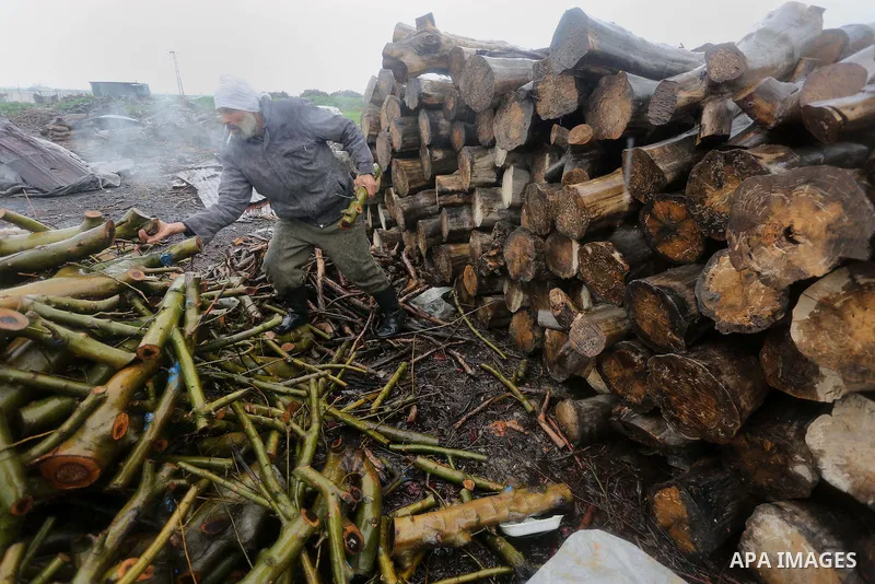 A Palestinian man collects firewood to sell to customers during a winter storm in Gaza city on Jan. 26, 2016. Photo by Mohammed Asad
