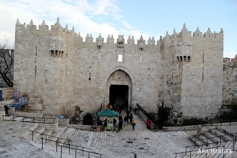Palestinians walk in front of Damascus gate in Jerusalem's Old city on Jan. 26, 2016. Photo by Mahfouz Abu Turk