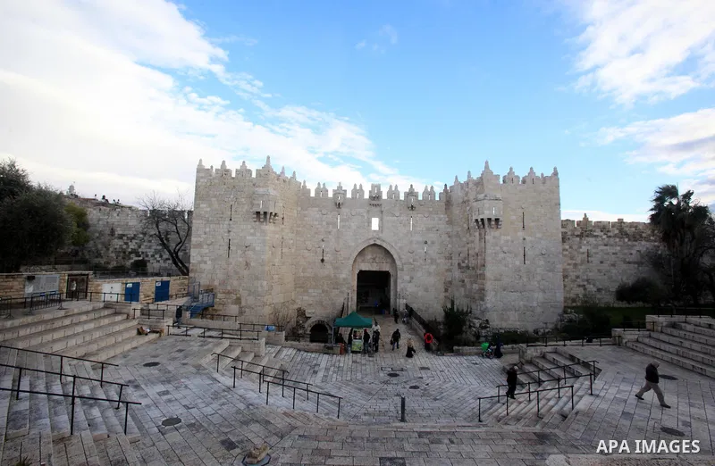 Palestinians walk in front of Damascus gate in Jerusalem's Old city on Jan. 26, 2016. Photo by Mahfouz Abu Turk