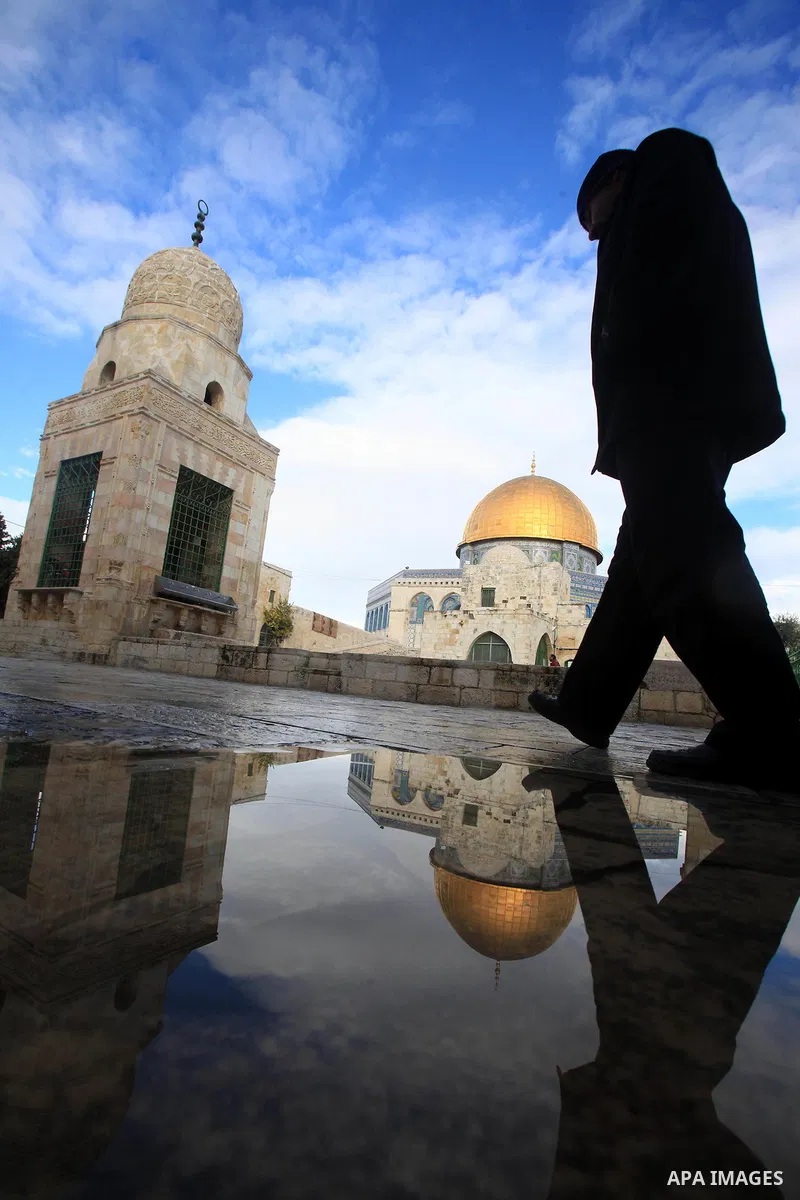 A Palestinian man walks in front of the Dome of the Rock mosque at al-Aqsa mosque compound in Jerusalem's Old city on Jan. 26, 2016. Photo by Mahfouz Abu Turk