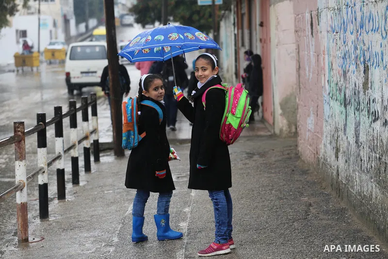 Palestinian students walk with their umbrella under the rain, during a winter storm in Gaza city, on january 27, 2016. Photo by Mohammed Asad
